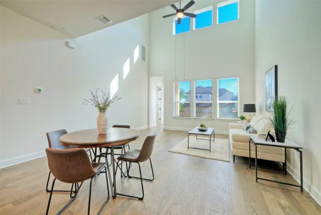 a kitchen with a sink a counter space and living room view