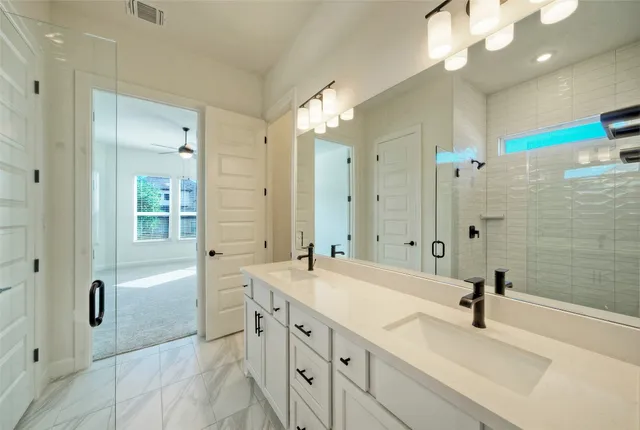 an empty room with windows and ceiling fan