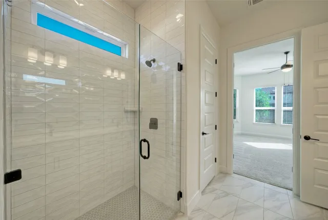 a bathroom with a tub sink shower and mirror