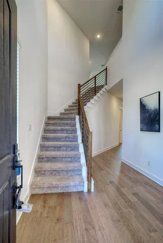 a view of entryway and hall with wooden floor