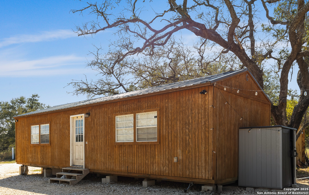 1304 County Road 777 Devine, TX 78016 - Photo 9 of 12 a view of a house with a tree