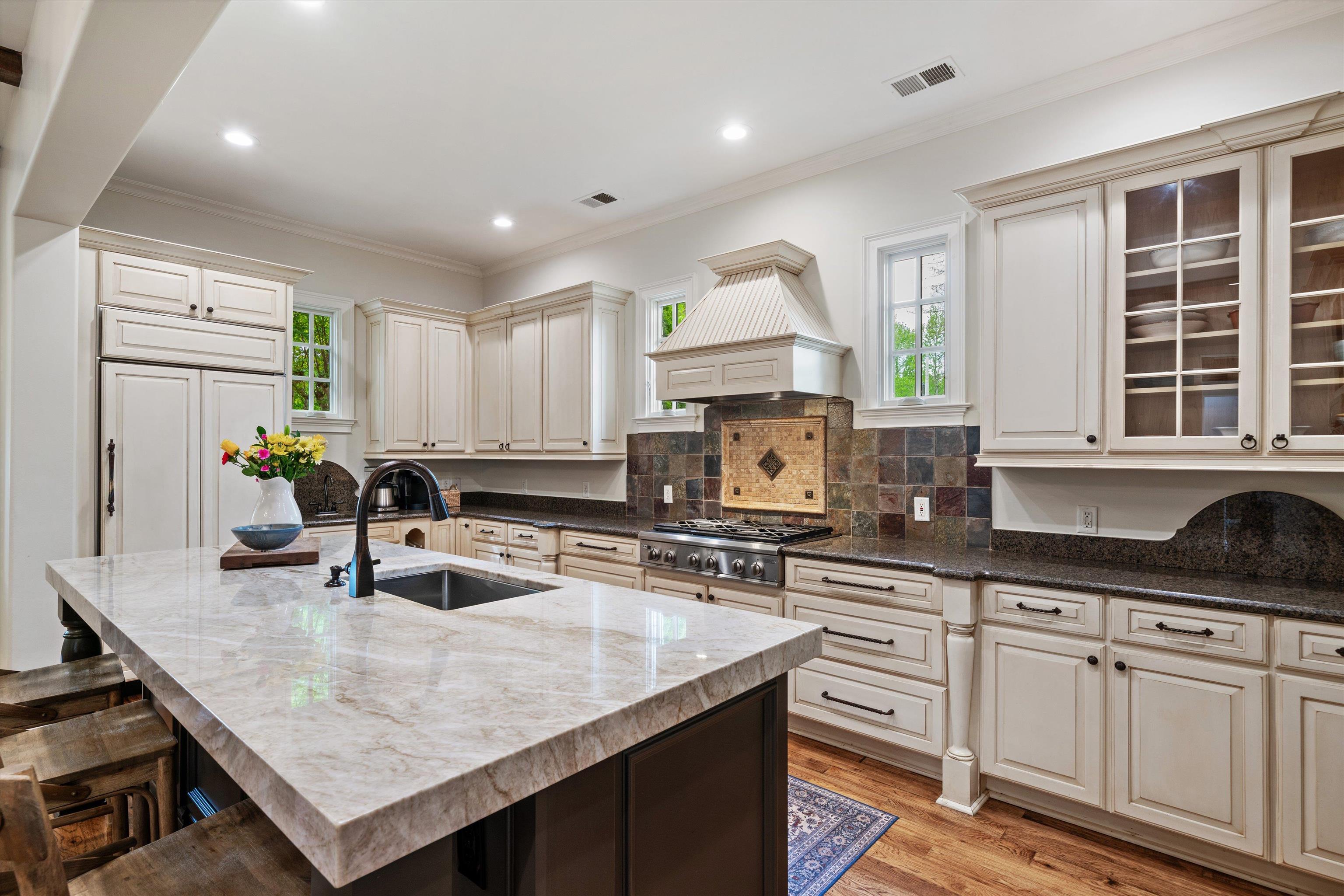 1328 Bridgepointe Drive Collierville, TN 38017 - Photo 12 of 40 a kitchen with granite countertop a sink a counter top space appliances and cabinets