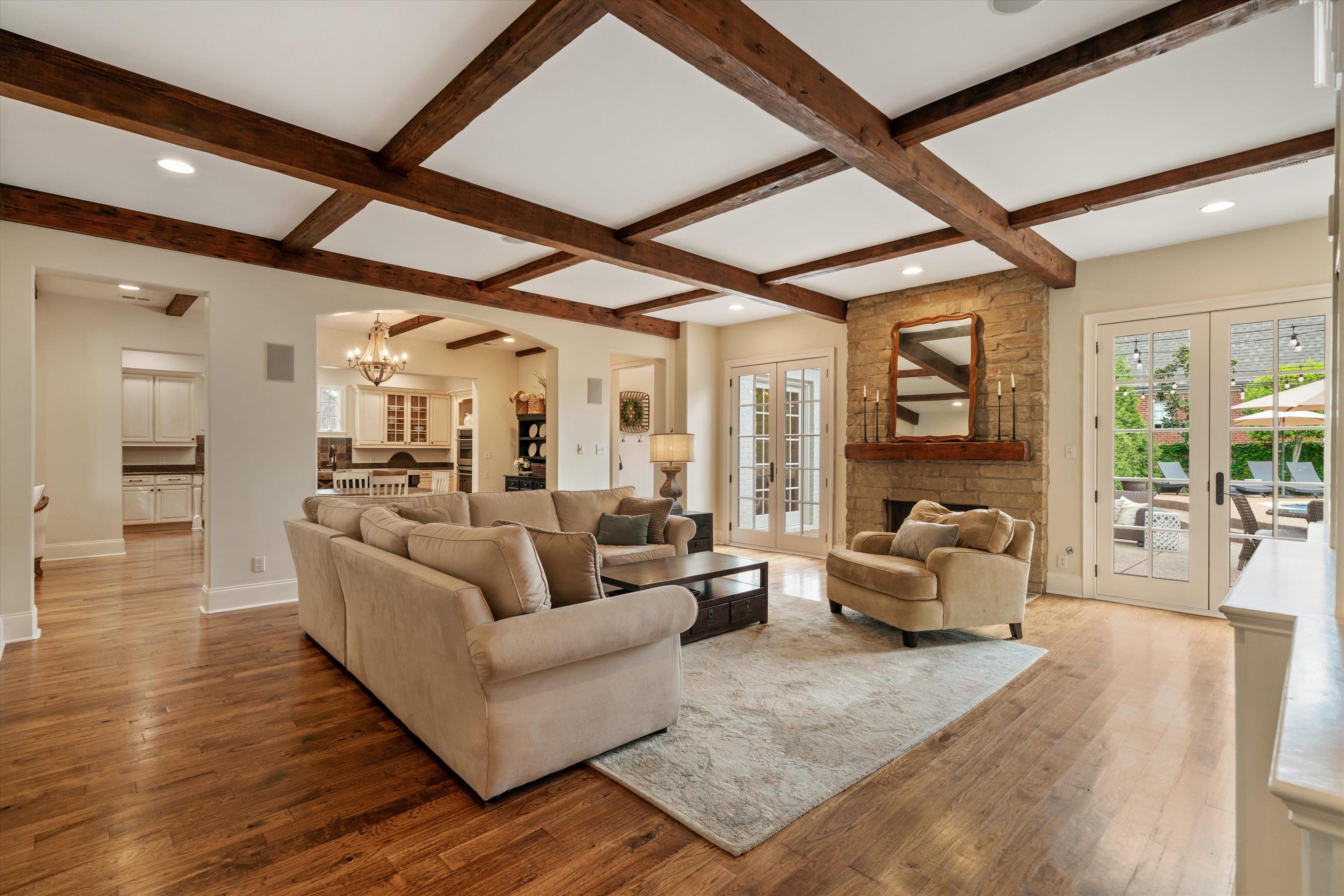 1328 Bridgepointe Drive Collierville, TN 38017 - Photo 14 of 40 Living area featuring french doors, hardwood / wood-style flooring, hanging lights, arched walkways, and coffered ceiling