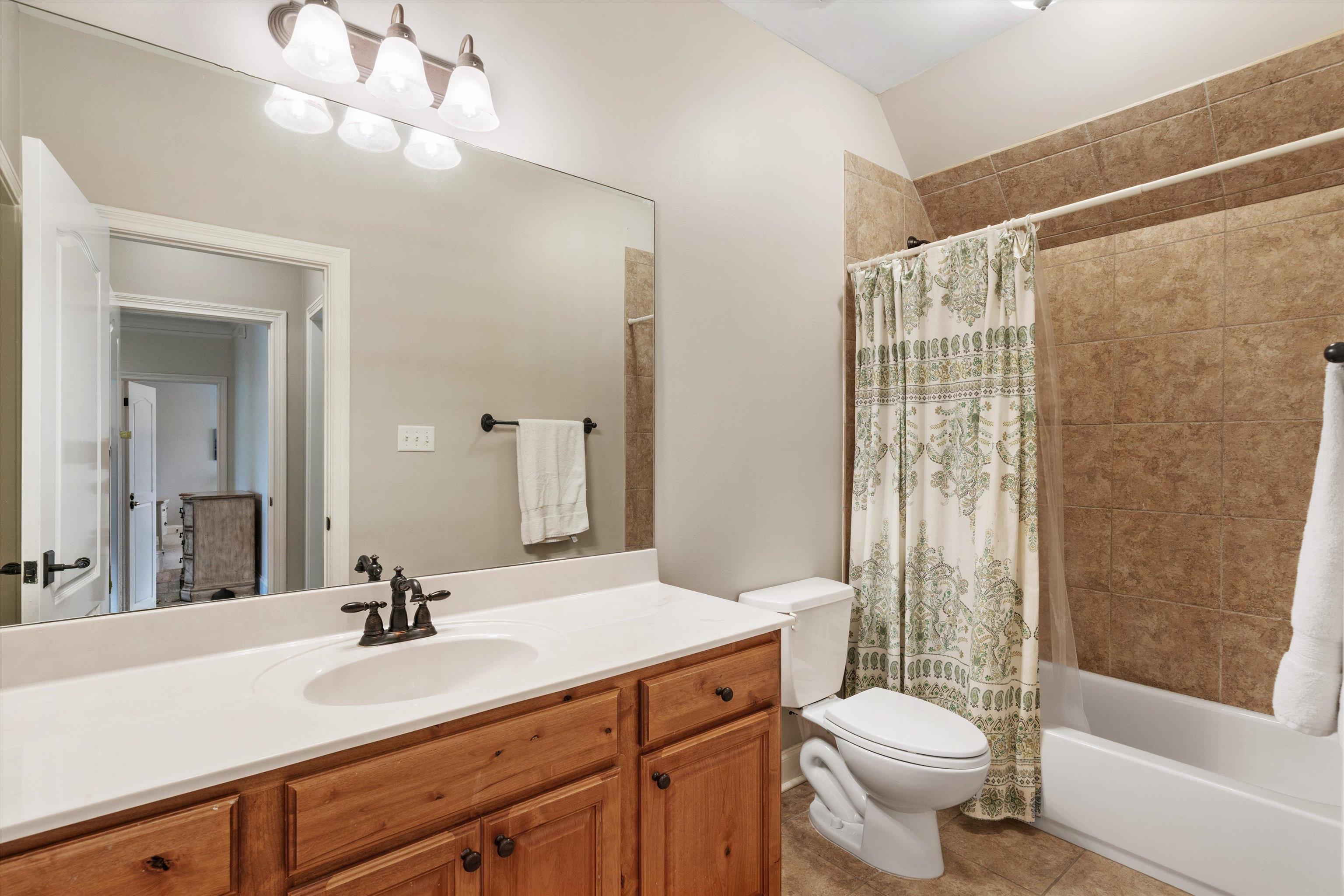1328 Bridgepointe Drive Collierville, TN 38017 - Photo 26 of 40 a bathroom with a double vanity sink toilet mirror and shower