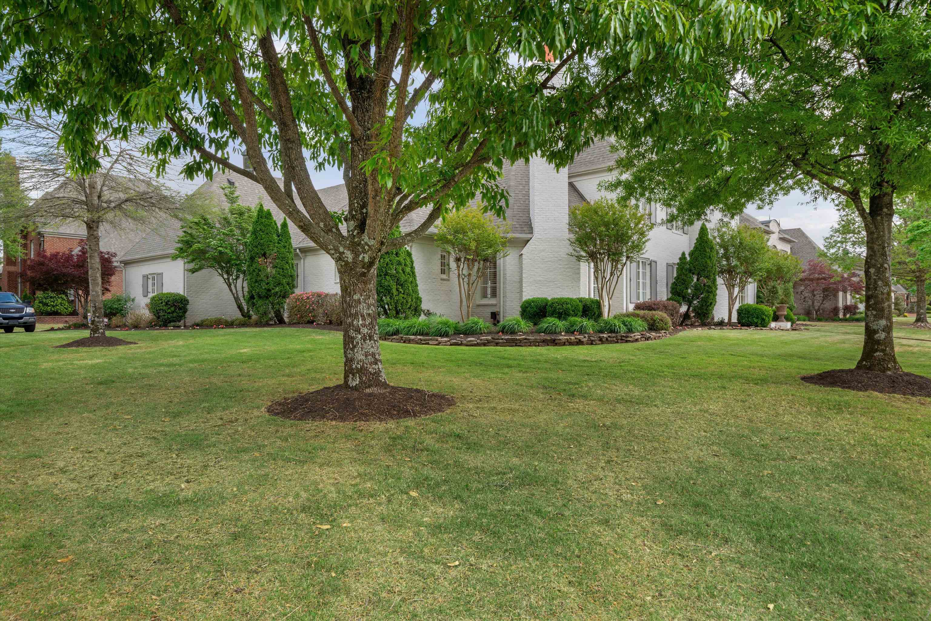 1328 Bridgepointe Drive Collierville, TN 38017 - Photo 3 of 40 a garden with trees in front of it