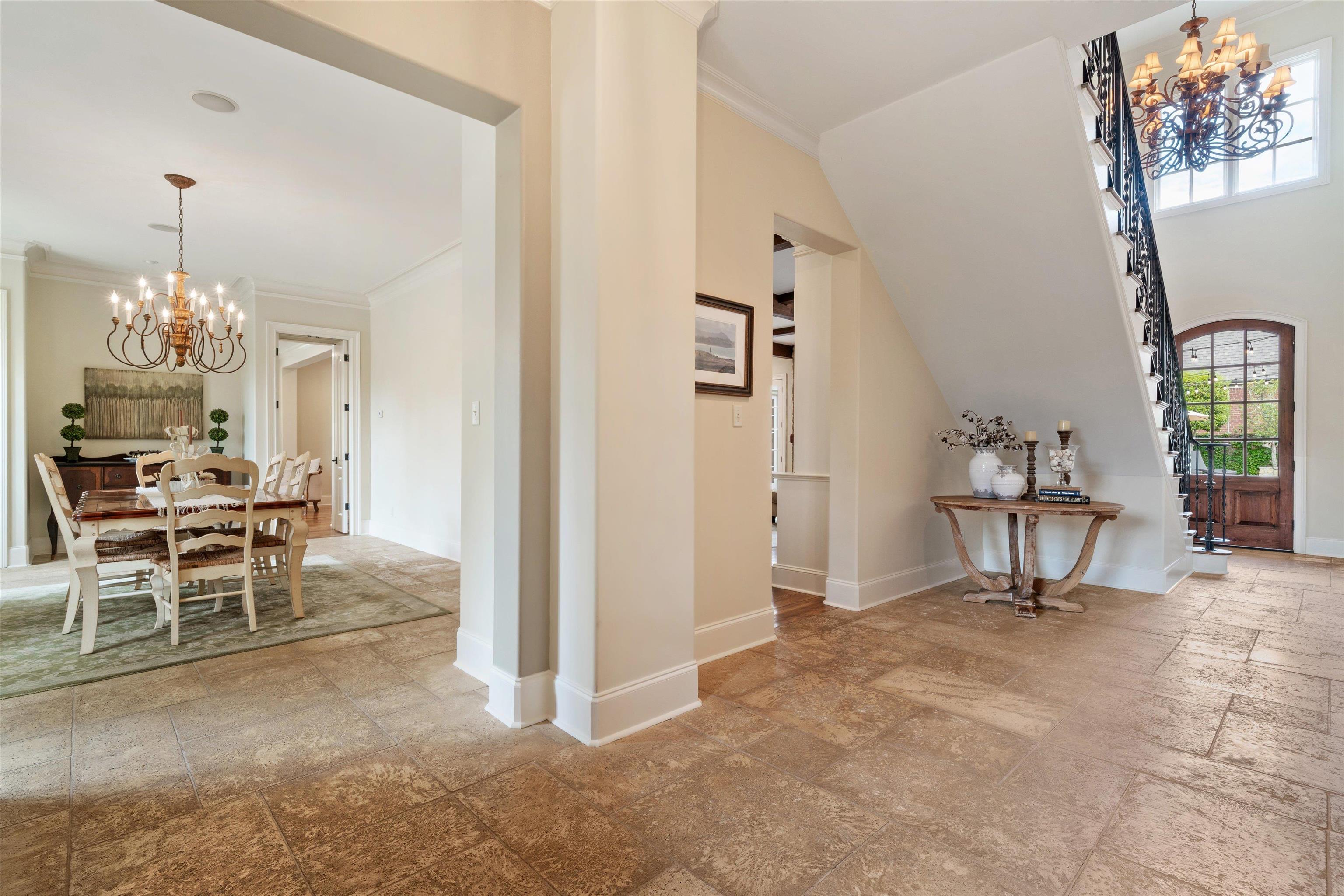 1328 Bridgepointe Drive Collierville, TN 38017 - Photo 4 of 40 a living room with furniture a dining table and a chandelier
