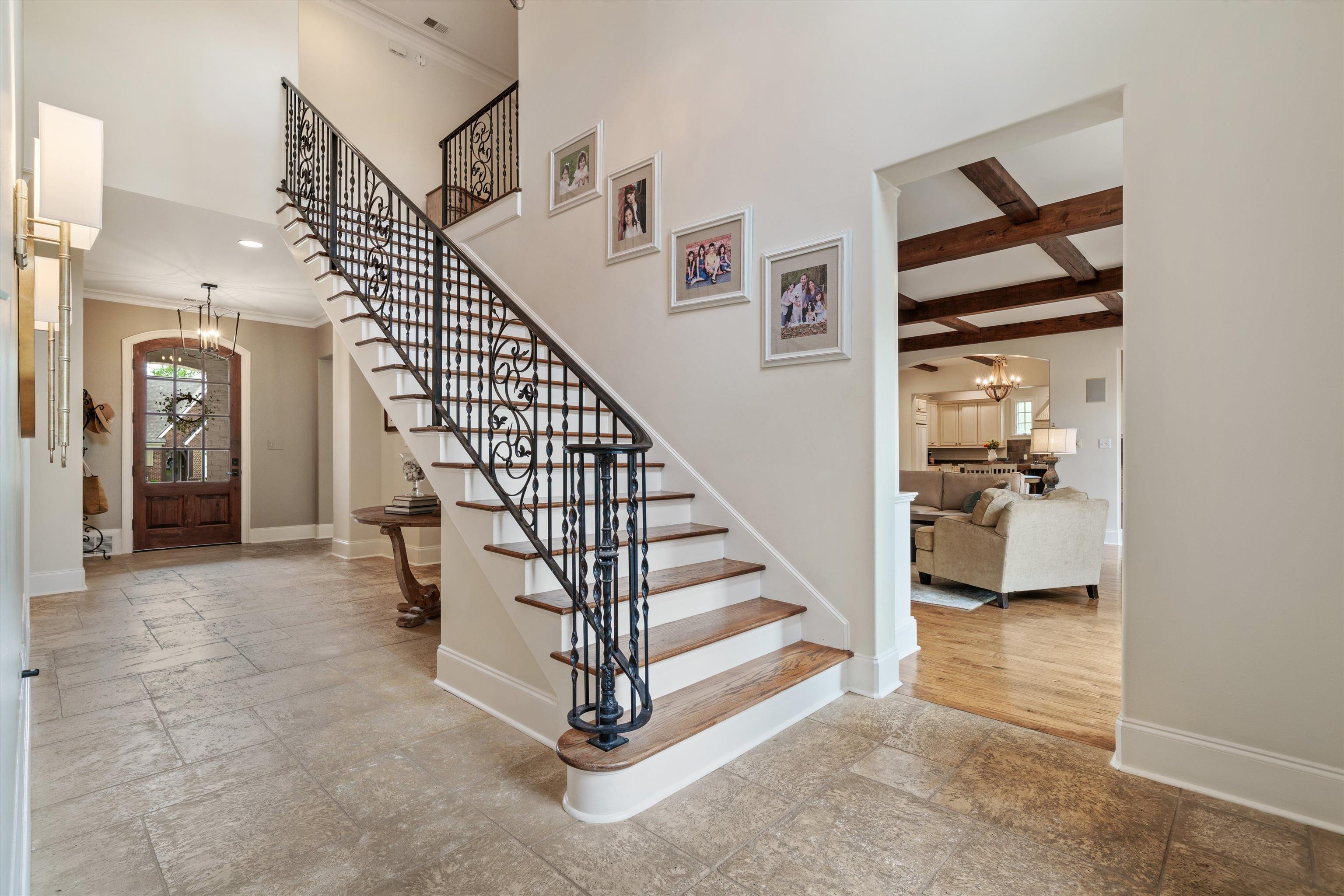 1328 Bridgepointe Drive Collierville, TN 38017 - Photo 5 of 40 Foyer entrance featuring hanging lights, stone tile floors, ornamental molding, and a high ceiling