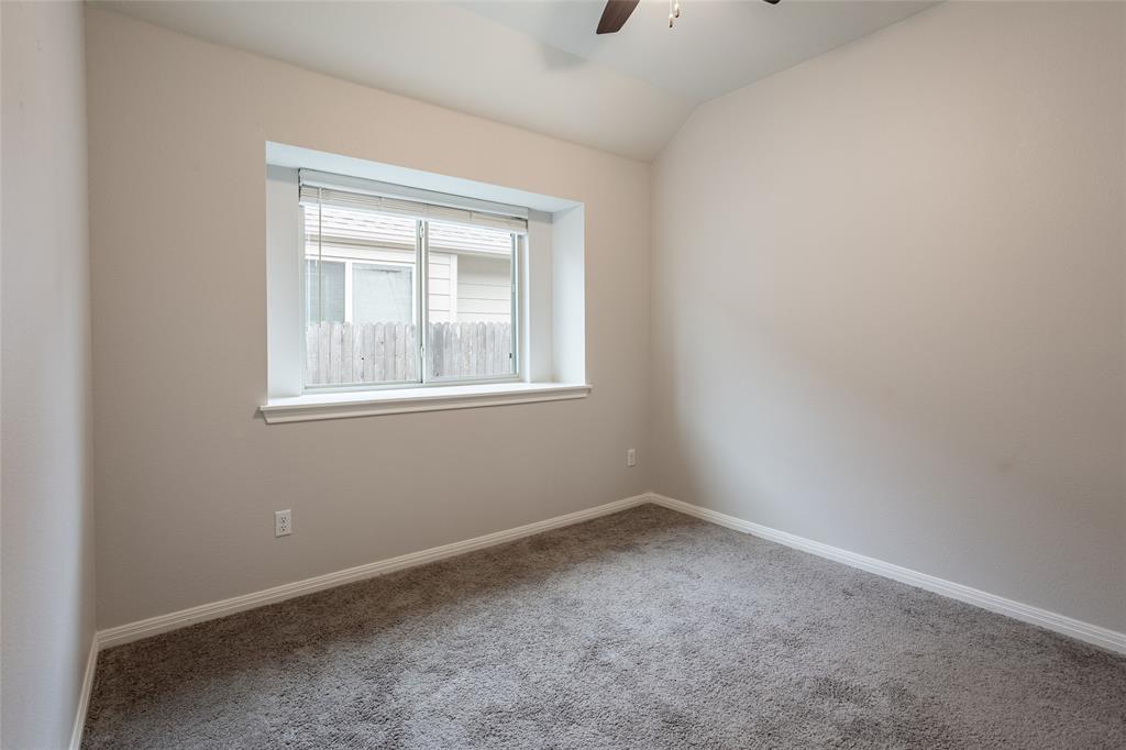 615 Stampede Road San Marcos, TX 78666 - Photo 7 of 26 A well-lit bedroom provides comfort and style, featuring soft carpet and a convenient ceiling fan.