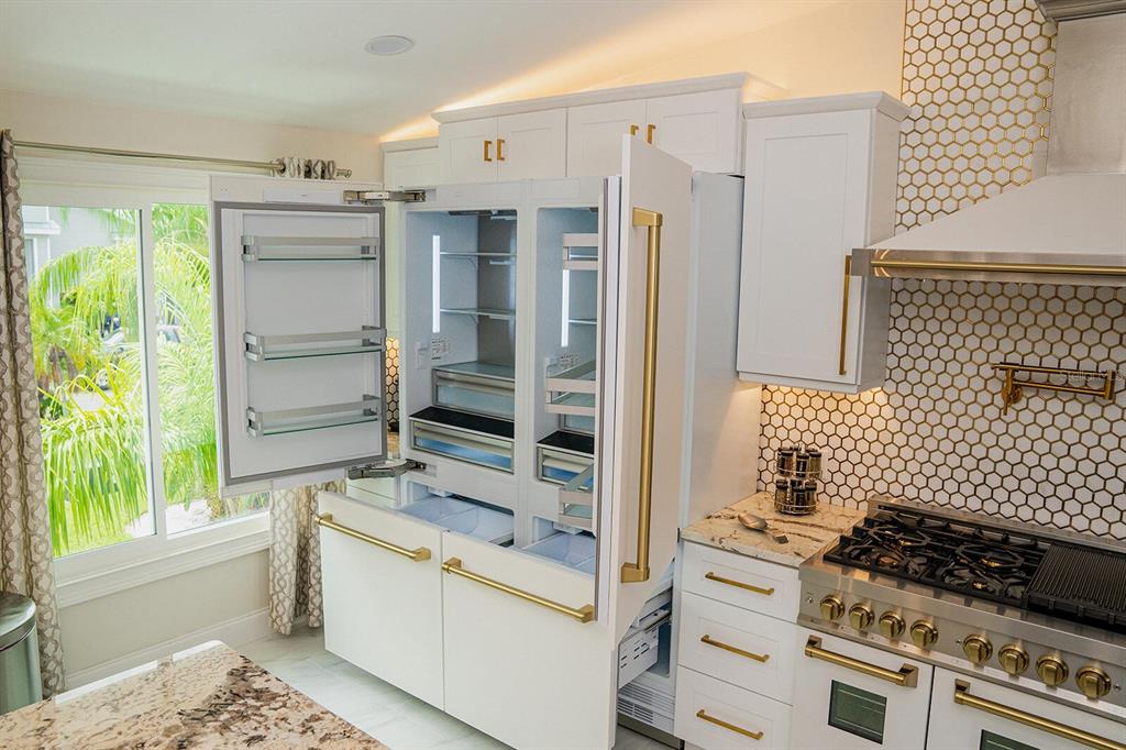 328 6th Avenue Indian Rocks Beach, FL 33785 - Photo 13 of 45 a kitchen with a stove and a refrigerator