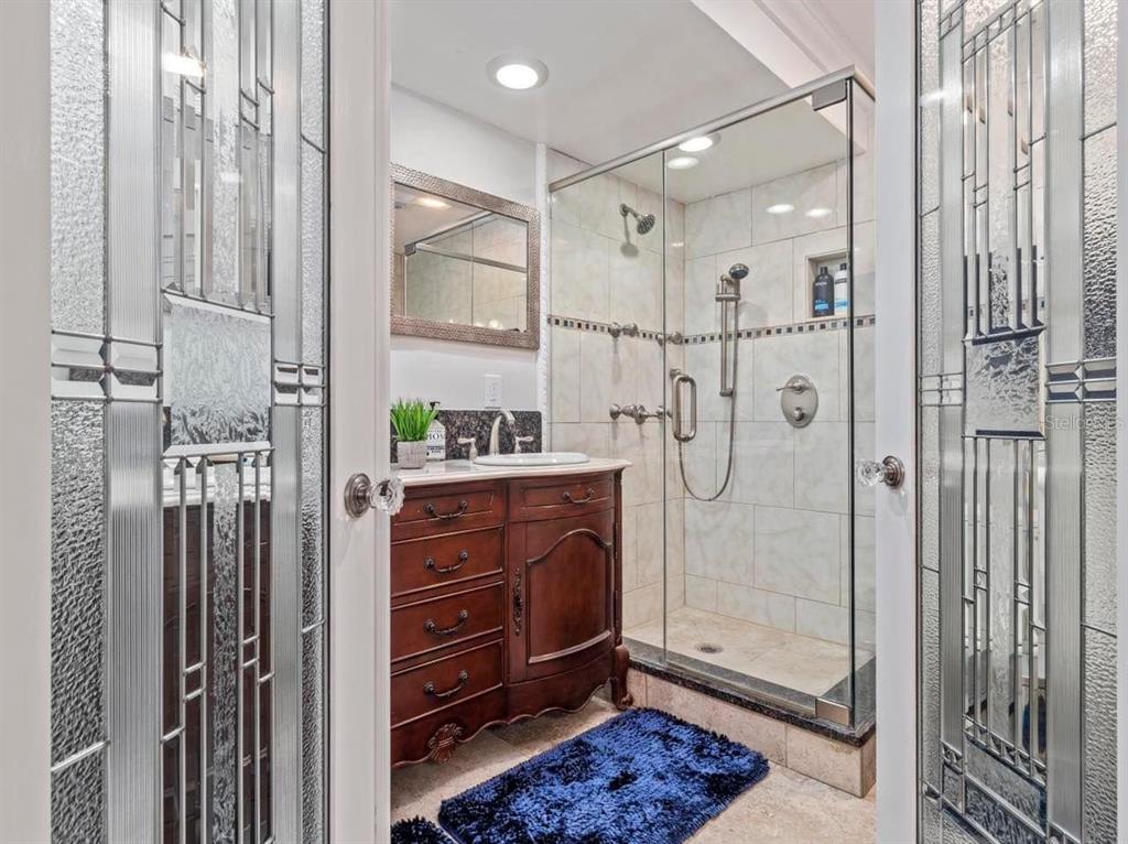 328 6th Avenue Indian Rocks Beach, FL 33785 - Photo 16 of 45 a bathroom with a shower sink and mirror