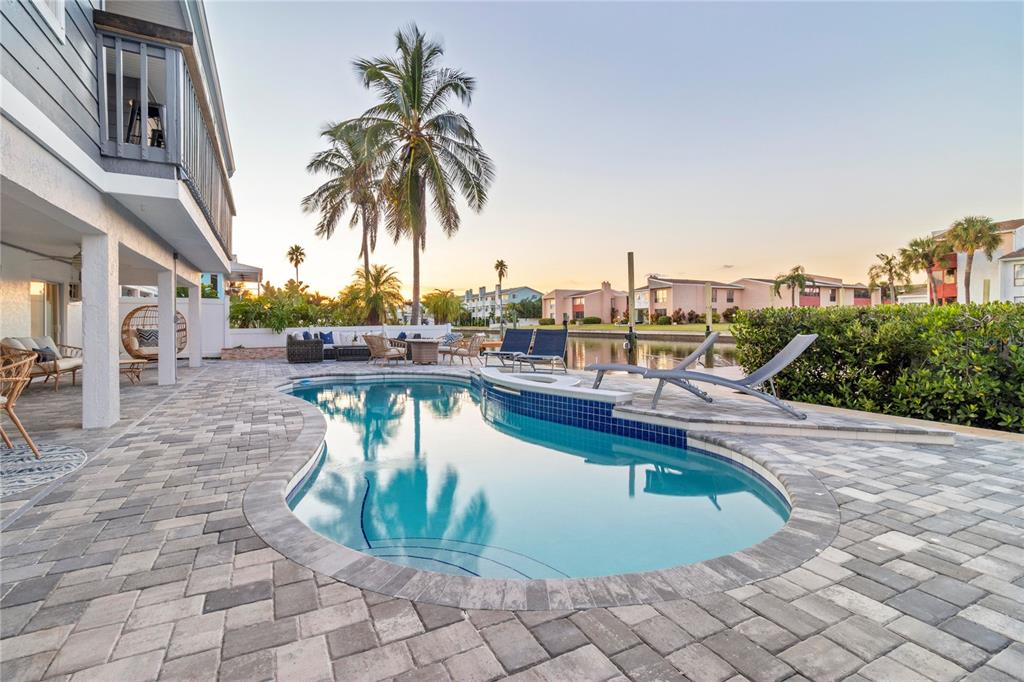 328 6th Avenue Indian Rocks Beach, FL 33785 - Photo 26 of 45 a view of a swimming pool with a lounge chair