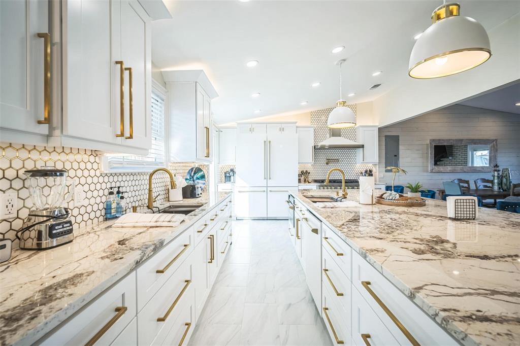 328 6th Avenue Indian Rocks Beach, FL 33785 - Photo 28 of 45 a large kitchen with stainless steel appliances granite countertop a sink stove and refrigerator