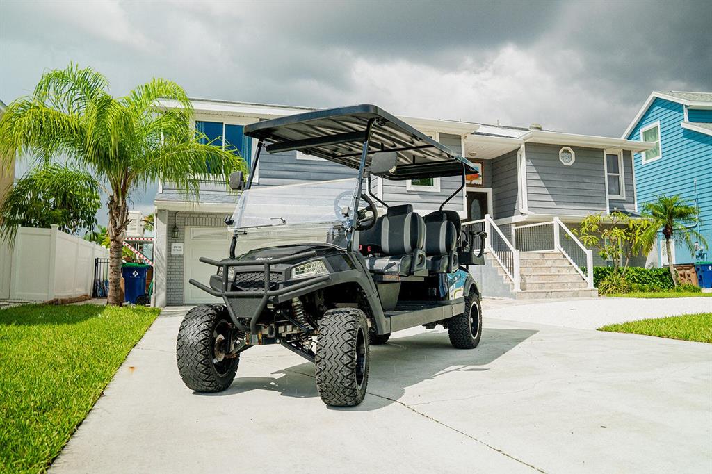 328 6th Avenue Indian Rocks Beach, FL 33785 - Photo 31 of 45 a view of a patio with table and chairs potted plants and palm tree