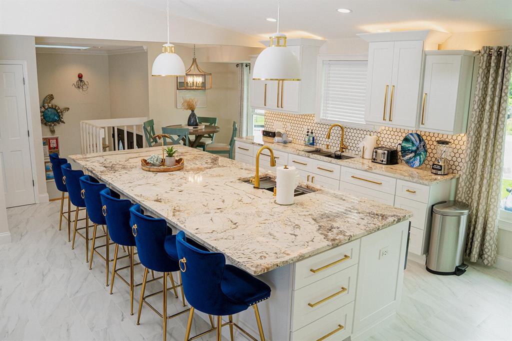 328 6th Avenue Indian Rocks Beach, FL 33785 - Photo 35 of 45 a kitchen with stainless steel appliances granite countertop a sink a stove and a refrigerator