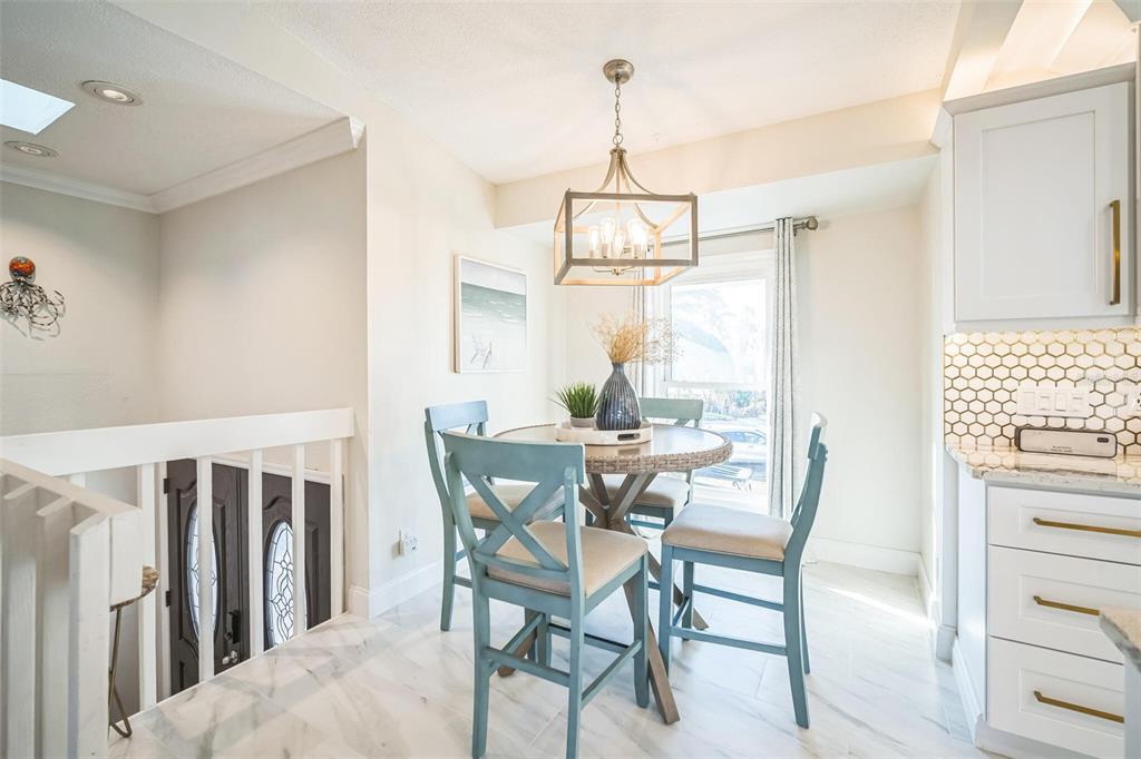 328 6th Avenue Indian Rocks Beach, FL 33785 - Photo 41 of 45 a view of a dining room with furniture window and wooden floor