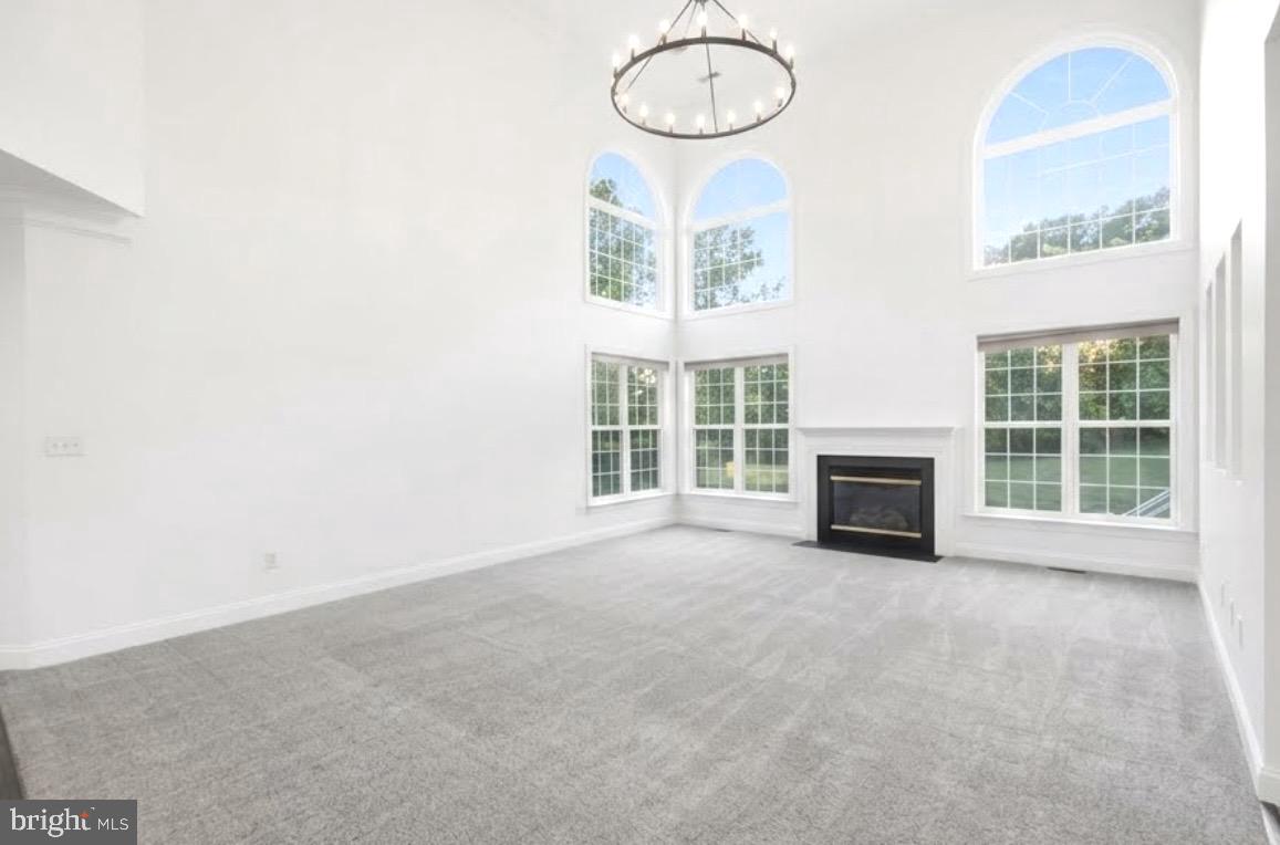 19081 Poplar Ridge Road Brandywine, MD 20613 - Photo 27 of 59 a view of an empty room with a fireplace and a window