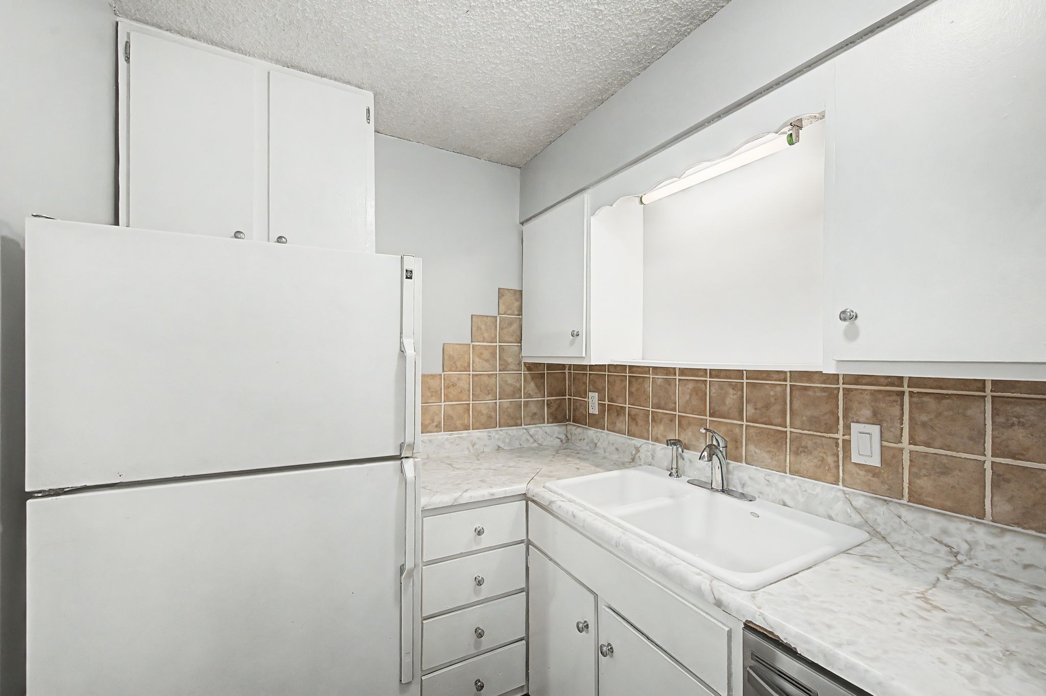110 Bellevue Road, Unit 30 Nashville, TN 37221 - Photo 11 of 43 a kitchen with a sink a refrigerator and cabinets