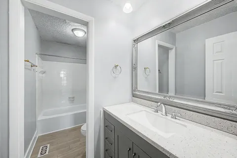 a bathroom with a bath tub with a shower