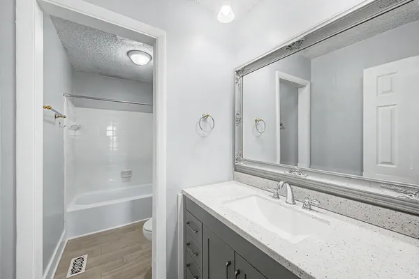 a bathroom with a bath tub with a shower