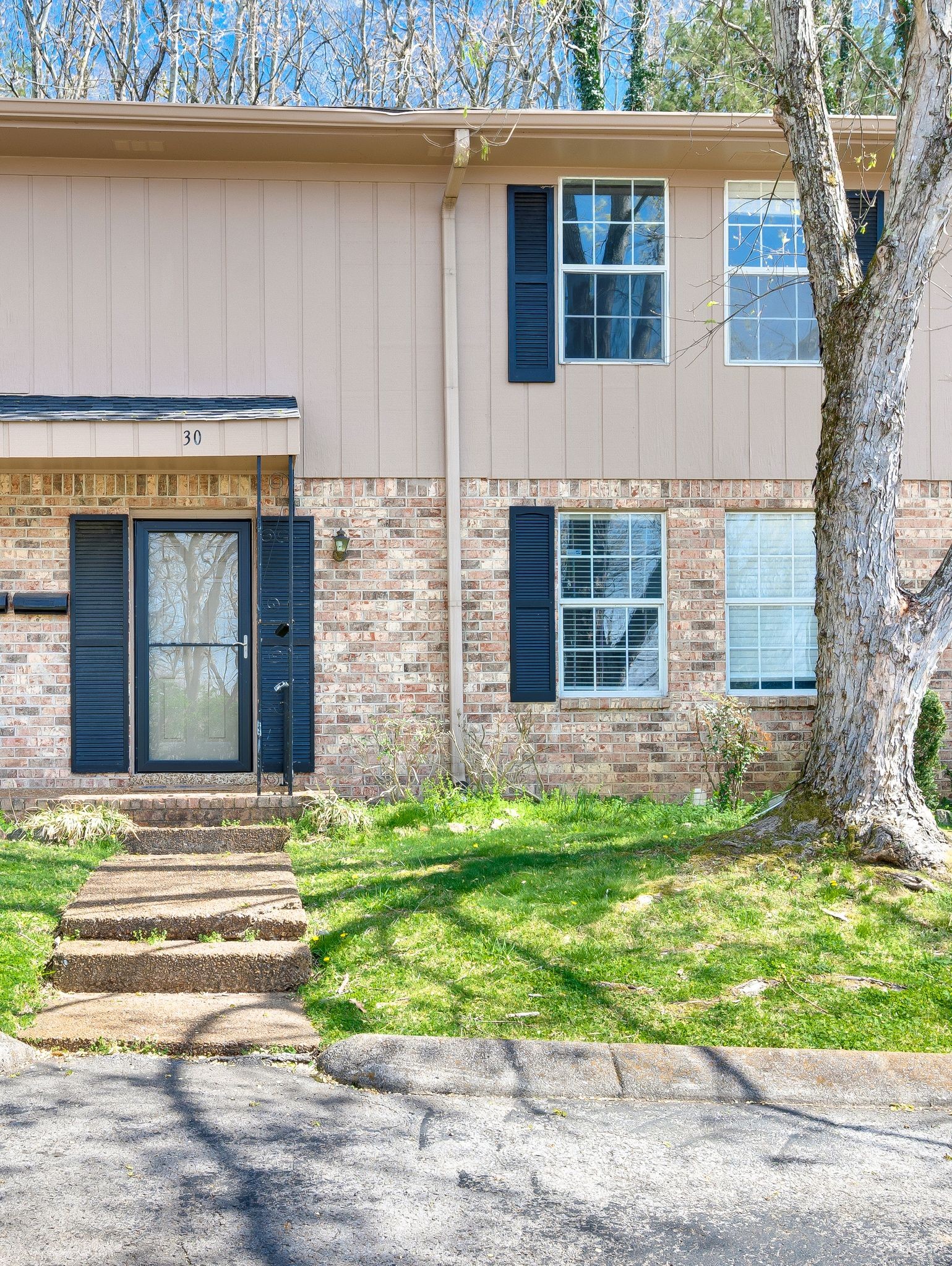 110 Bellevue Road, Unit 30 Nashville, TN 37221 - Photo 2 of 43 a front view of a house with a yard