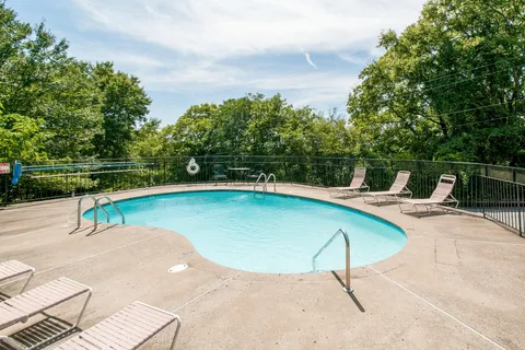 a sign that is sitting in the grass next to a road