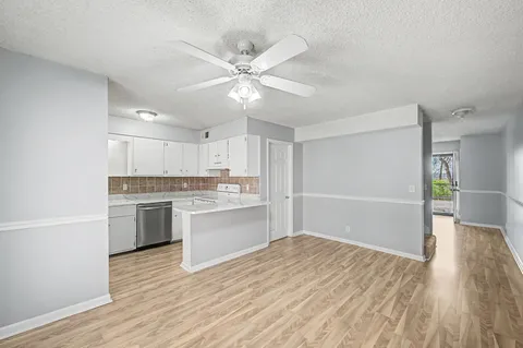 a open kitchen with white cabinets and sink