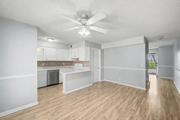 a open kitchen with white cabinets and sink
