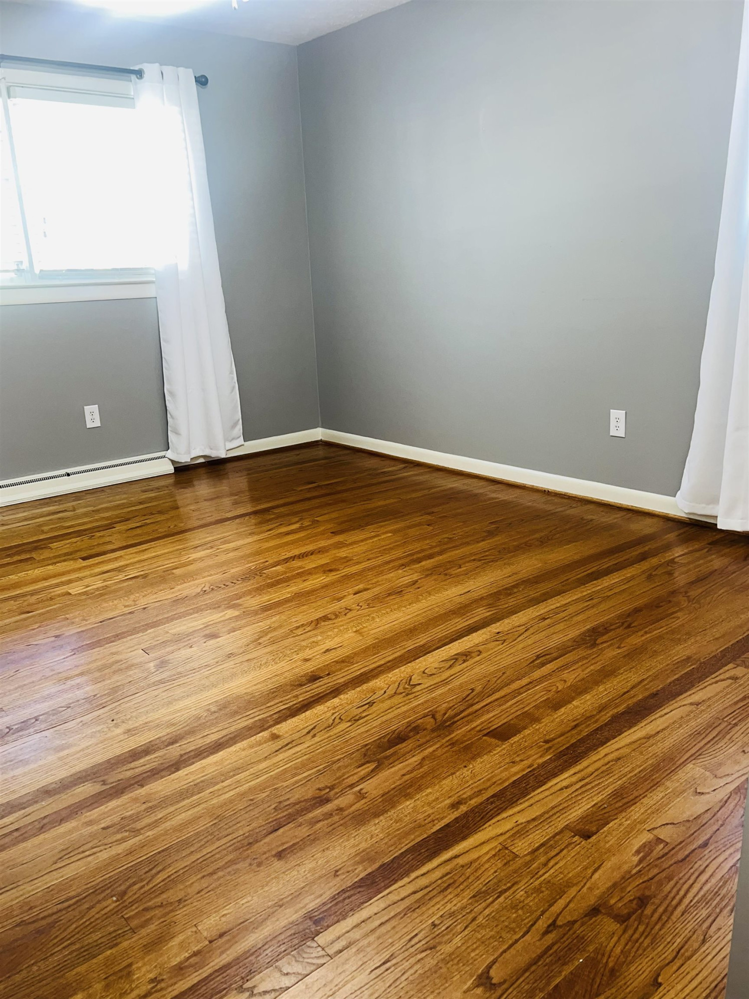2419 Raeford Road Fayetteville, NC 28305 - Photo 13 of 36 a view of an empty room with wooden floor and a window