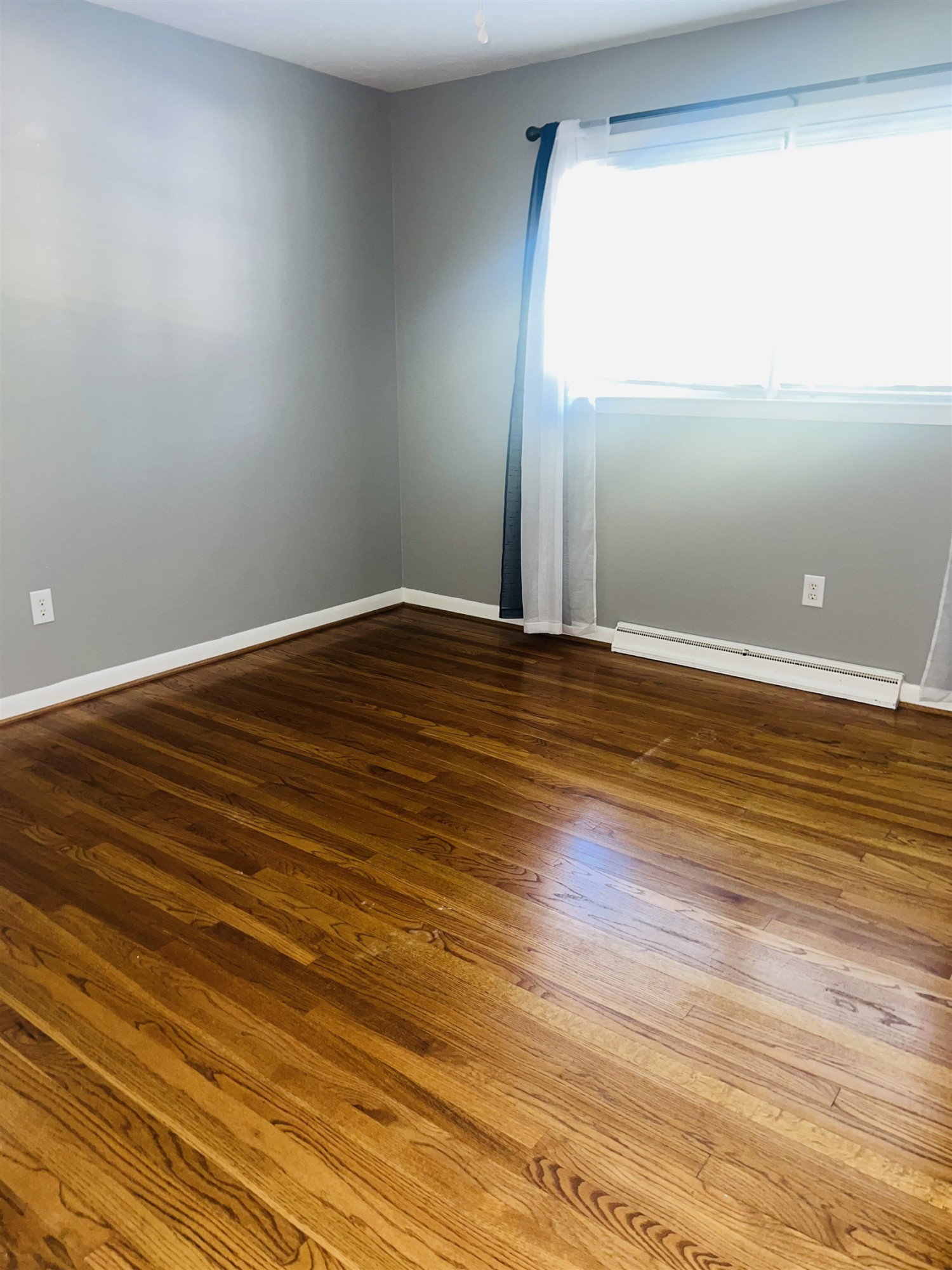 2419 Raeford Road Fayetteville, NC 28305 - Photo 14 of 36 a view of an empty room with wooden floor and a window