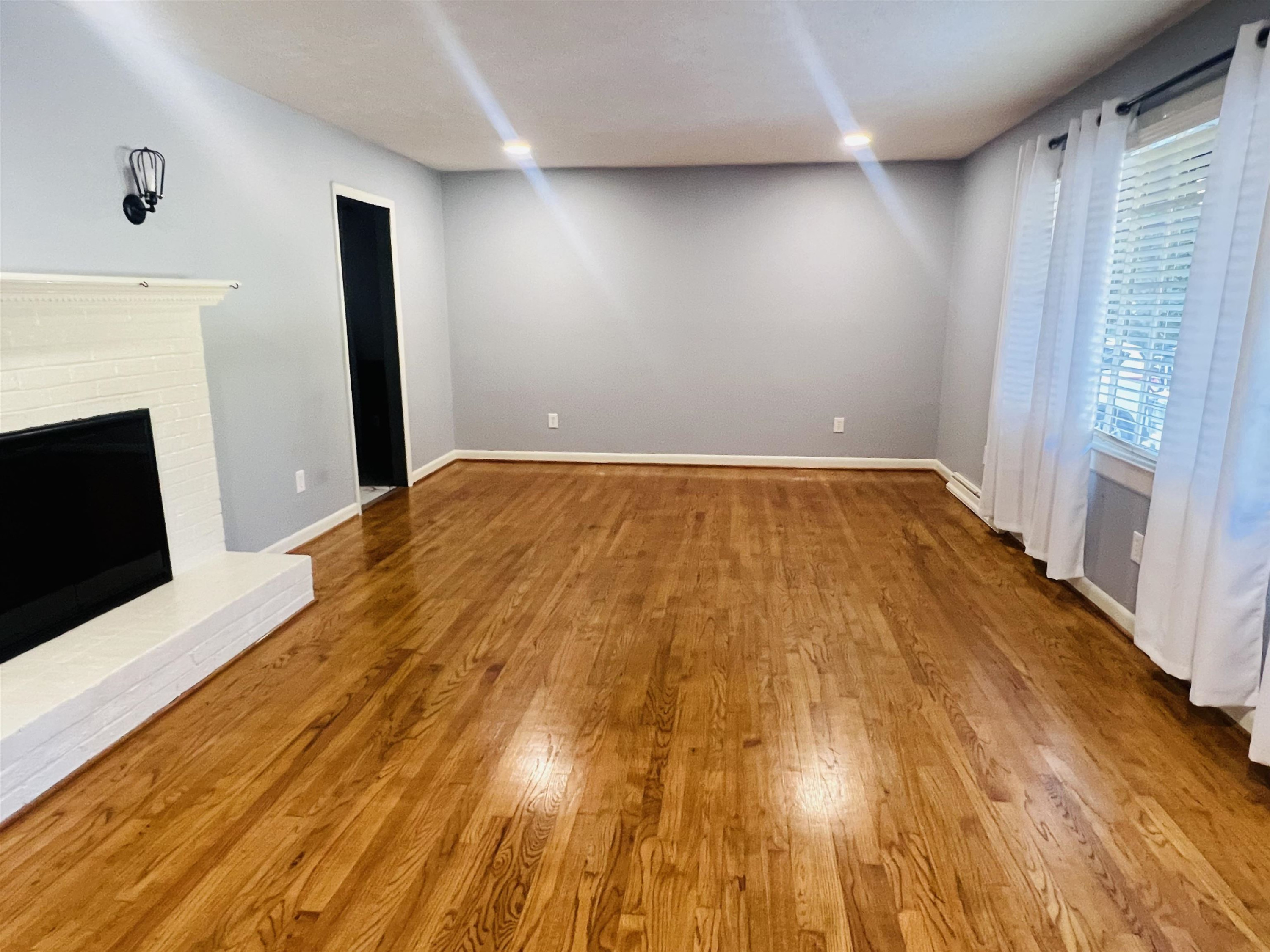 2419 Raeford Road Fayetteville, NC 28305 - Photo 2 of 36 a bedroom with a bed and a fireplace