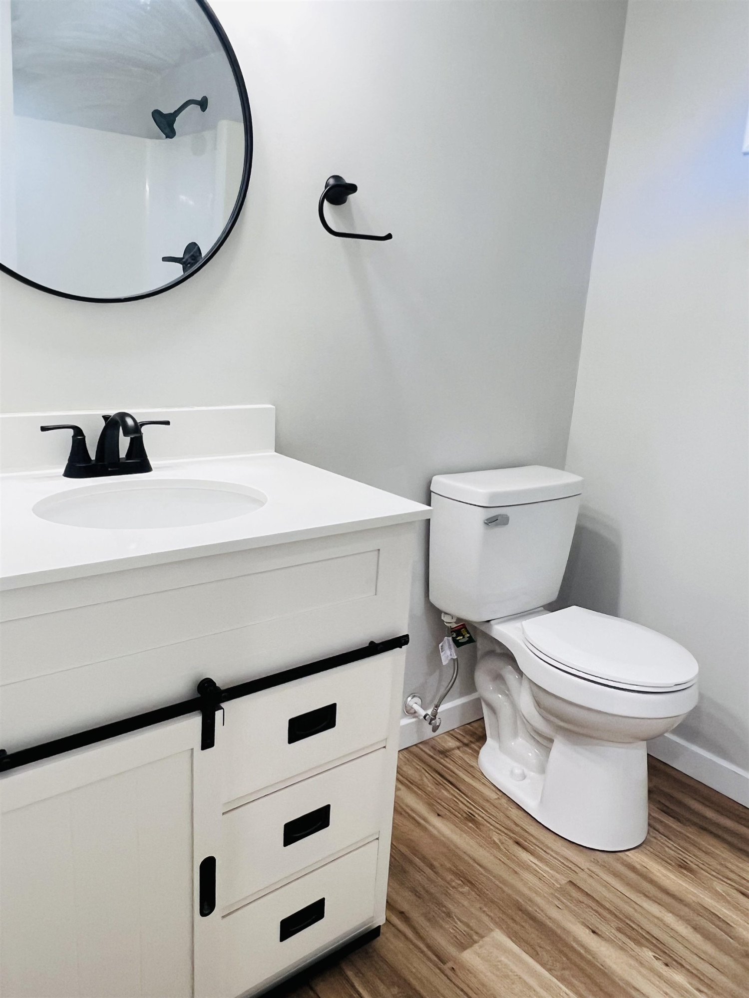 2419 Raeford Road Fayetteville, NC 28305 - Photo 27 of 36 a bathroom with a sink a toilet and a mirror