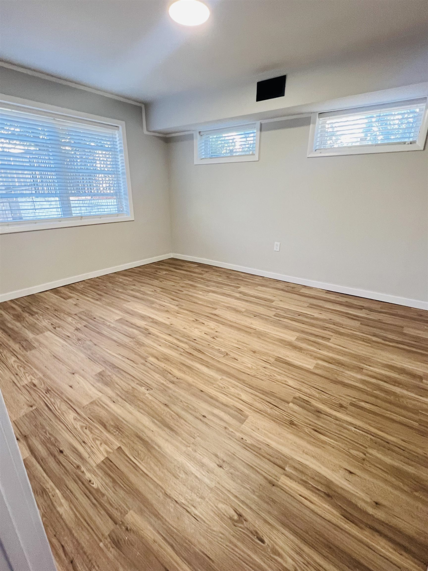 2419 Raeford Road Fayetteville, NC 28305 - Photo 28 of 36 an empty room with wooden floor and windows