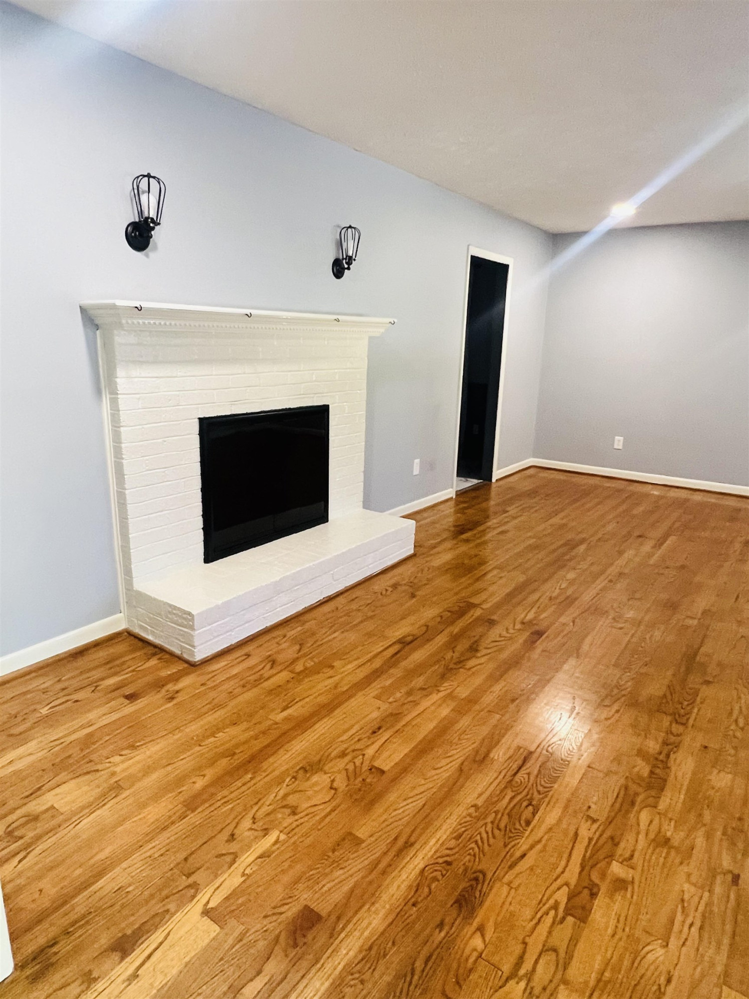 2419 Raeford Road Fayetteville, NC 28305 - Photo 3 of 36 a view of empty room with wooden floor and fireplace