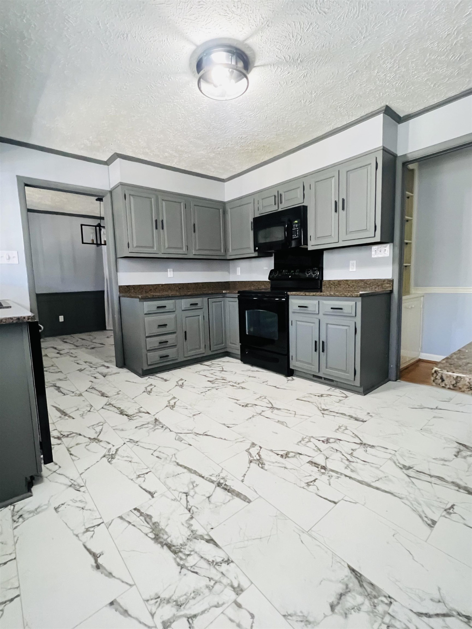 2419 Raeford Road Fayetteville, NC 28305 - Photo 7 of 36 a kitchen with a stove and a refrigerator