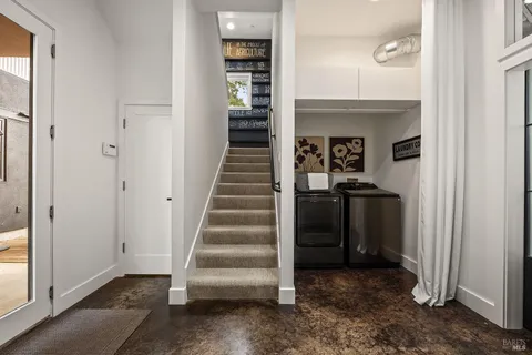 a living room with furniture a large window and a table