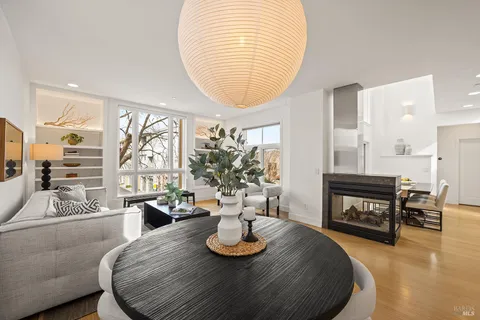 a living room with furniture and large windows