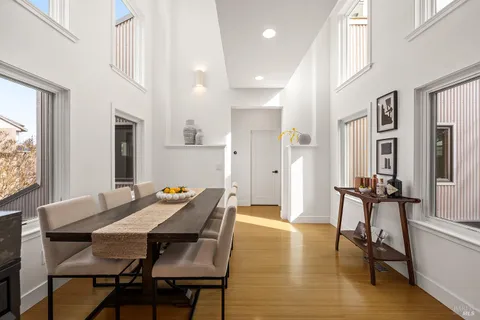 a view of a dining room with furniture and a chandelier