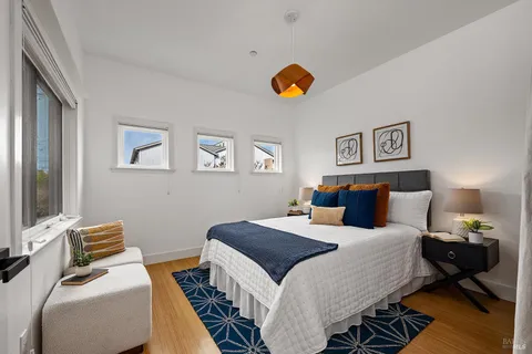 a bedroom with a bed and a chandelier