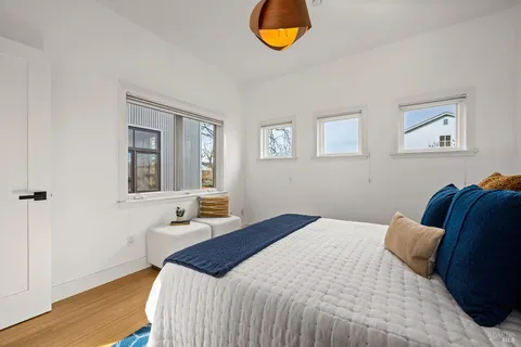 a view of a hallway with wooden floor and dining room