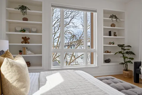 a bedroom with a bed and a window