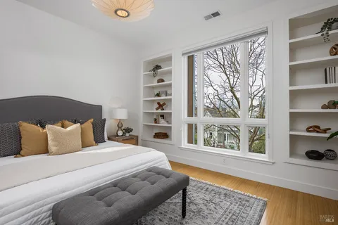 a bedroom with a bed and wooden floor