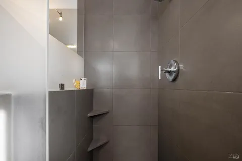 a bathroom with a tub a sink and a window