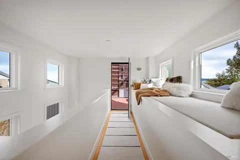 a view of balcony with wooden floor and outdoor seating