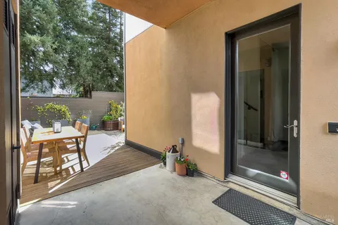 a view of a balcony with chair and front door