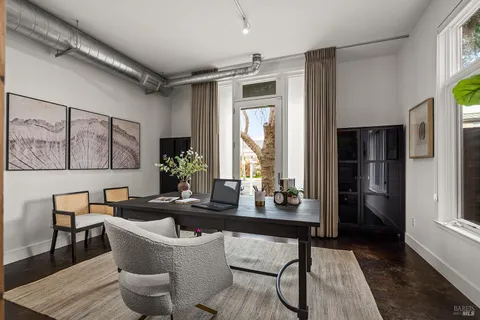 a dining room with furniture and window