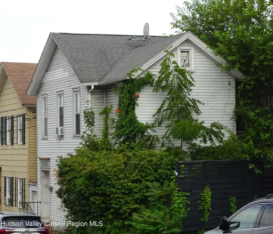 a aerial view of a house next to a yard