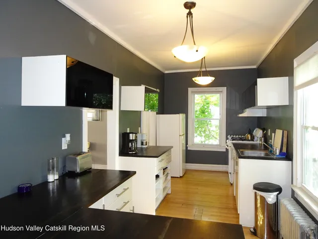 a kitchen with a sink a refrigerator and window