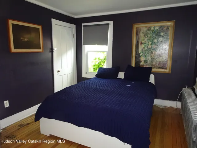 a bed sitting in a bedroom next to a window