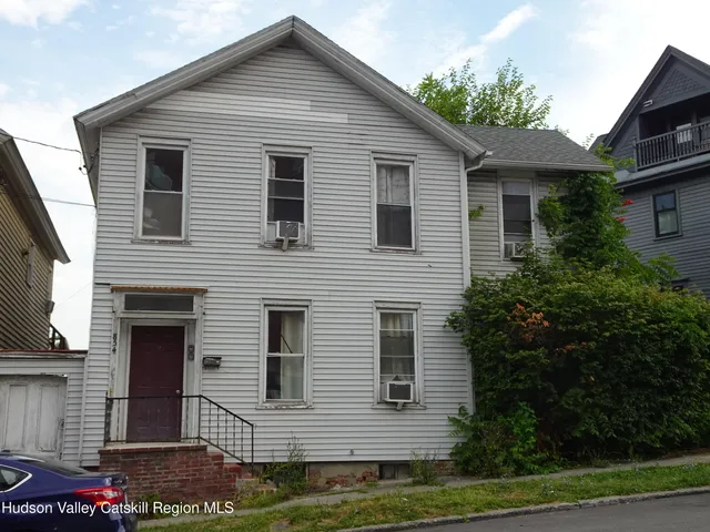 a couple of cars parked in front of buildings