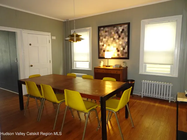 a view of a dining room with furniture and window